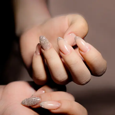 Nude and glitter manicure on long nails